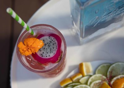 Top view close up of a tropical drink and the bottle of Yacht Life Vodka.