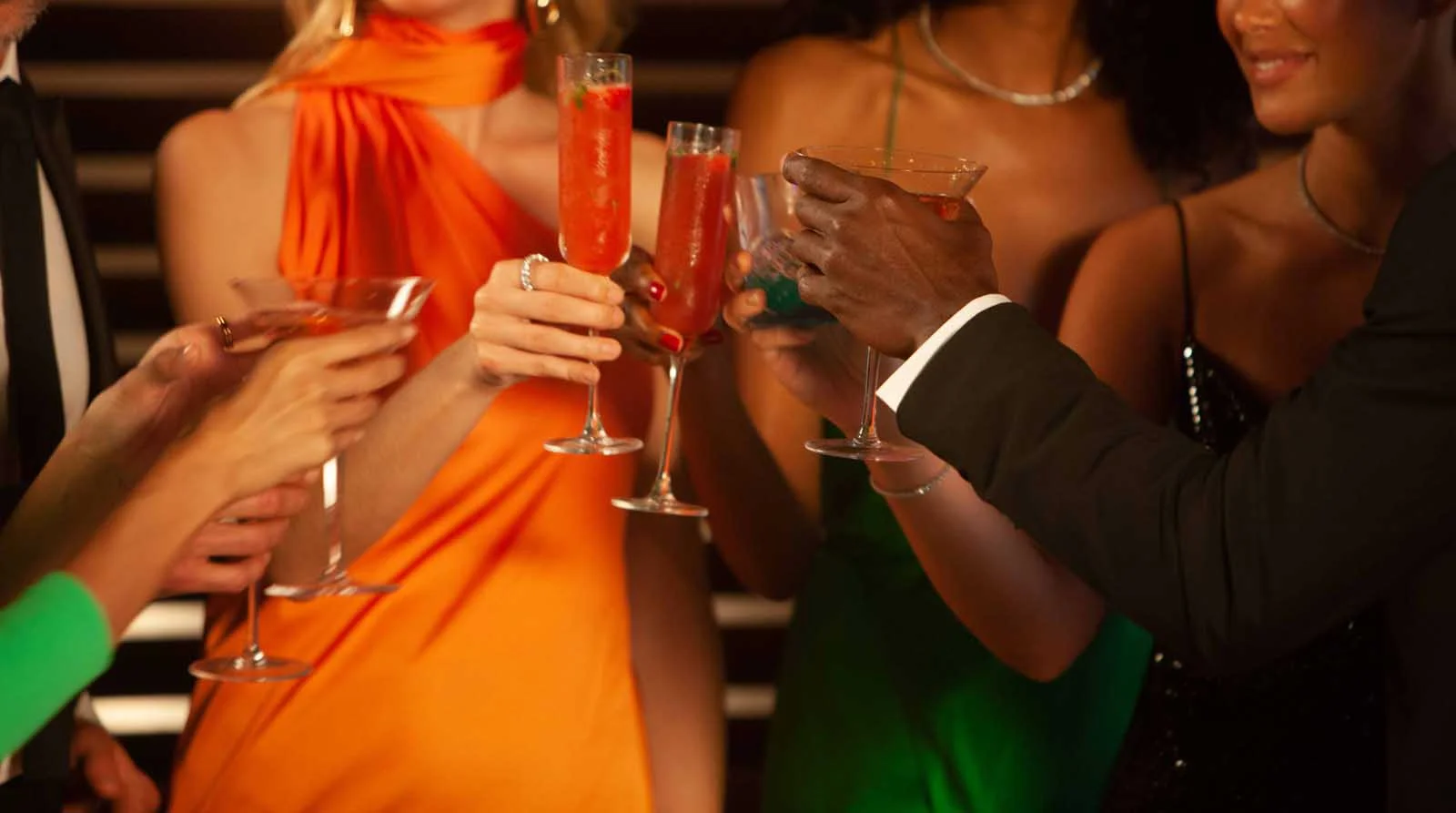 Closeup of group of people toasting in an elegant setting.