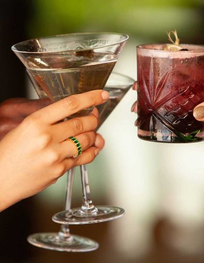 Close up of mixed drinks toasting.