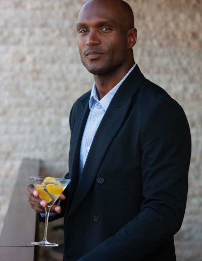 Man staring at camera holding a martini