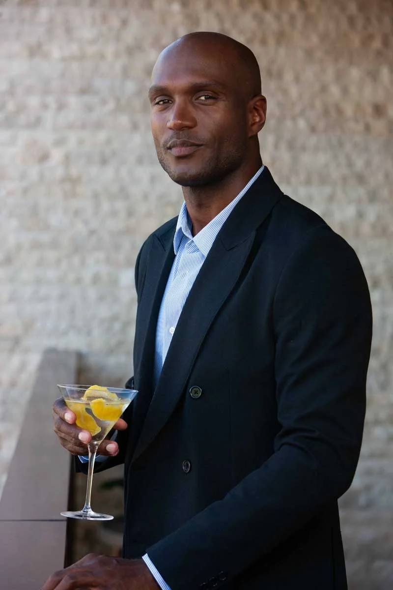 Man staring at camera holding a martini