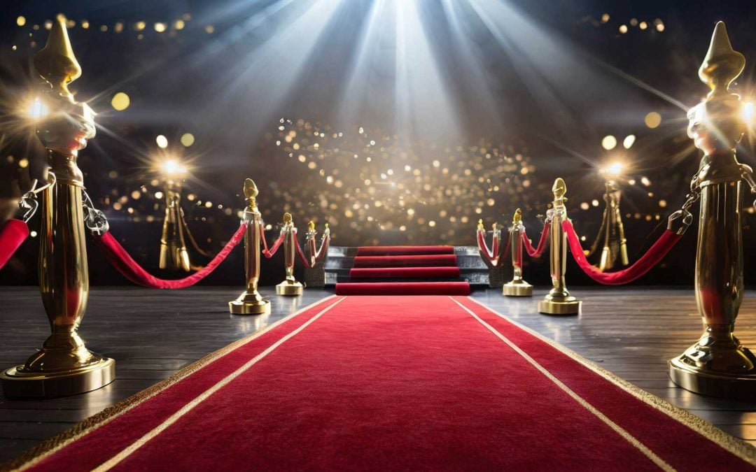 Rolled out red carpet with rope lining and a spot light ready for you to walk down.